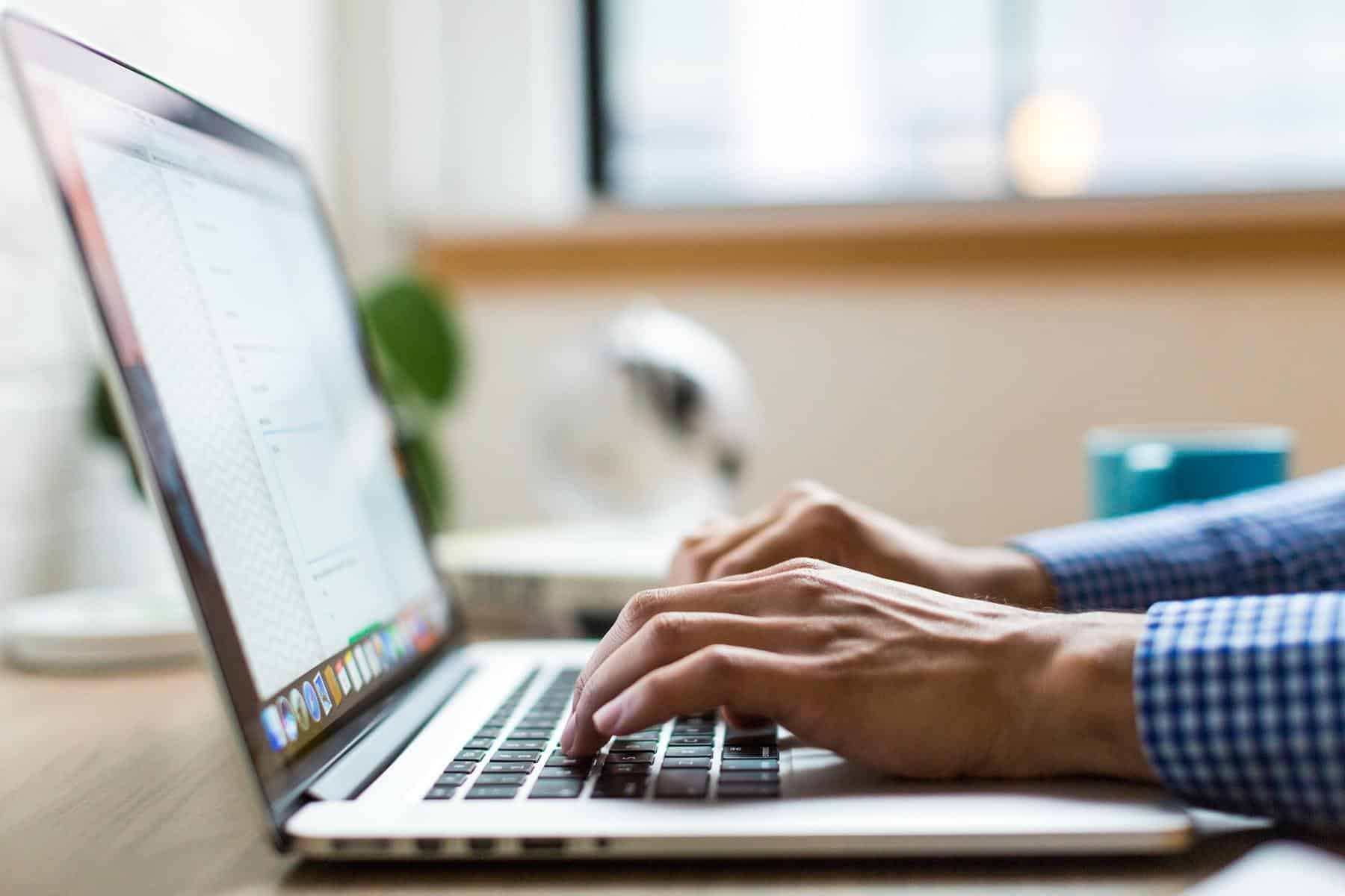 Man writing on laptop