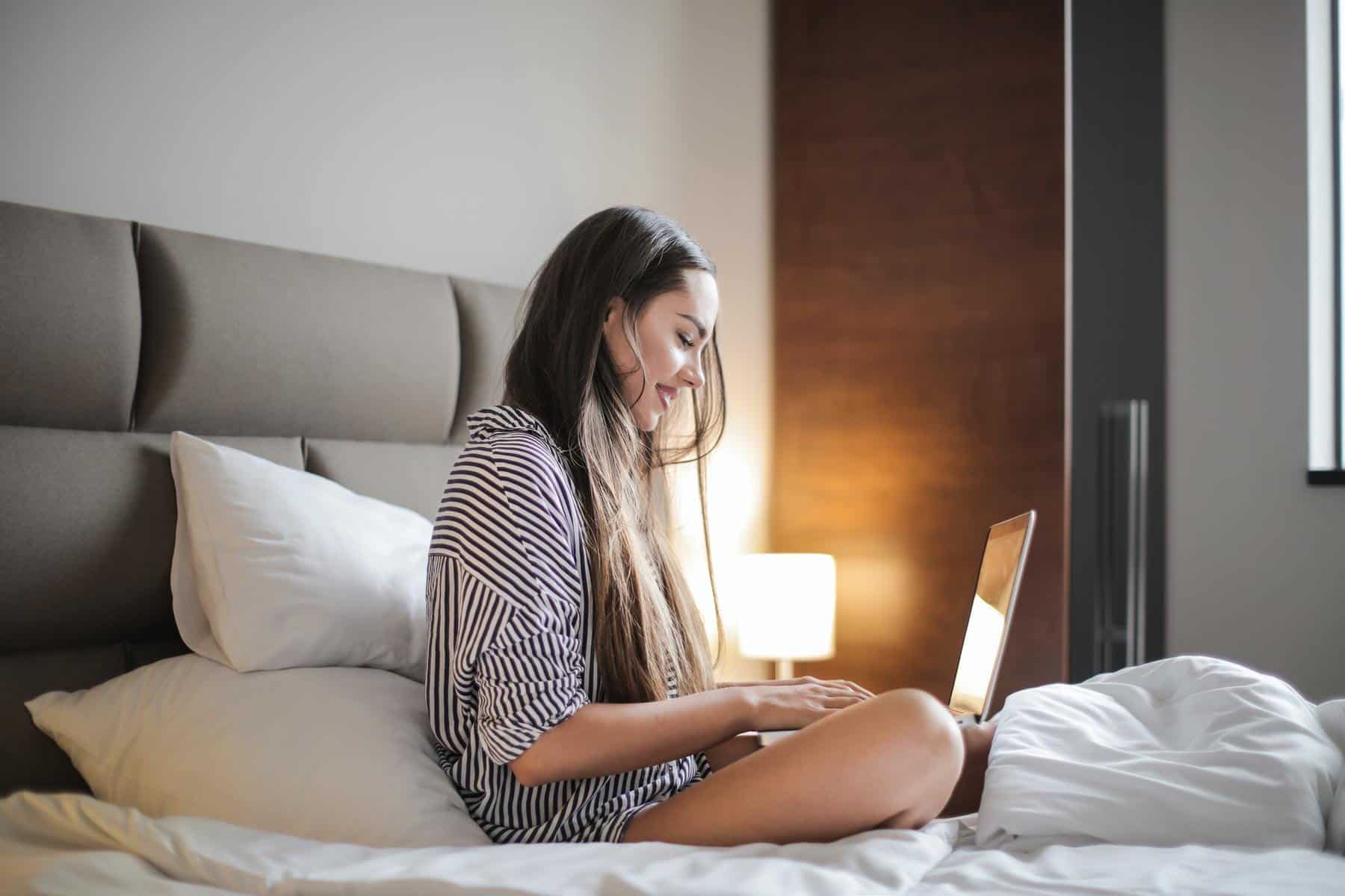 Happy woman using laptop