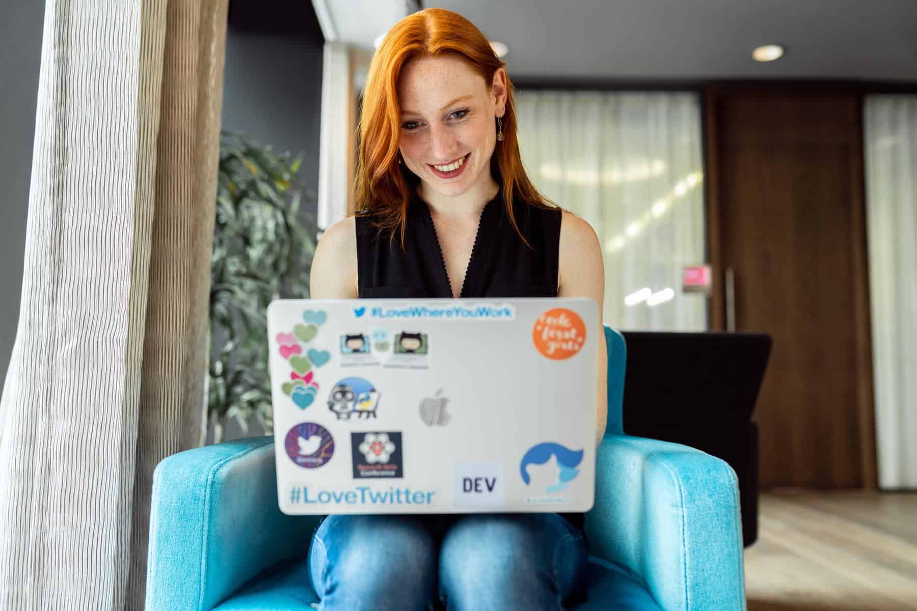 Woman happily using laptop