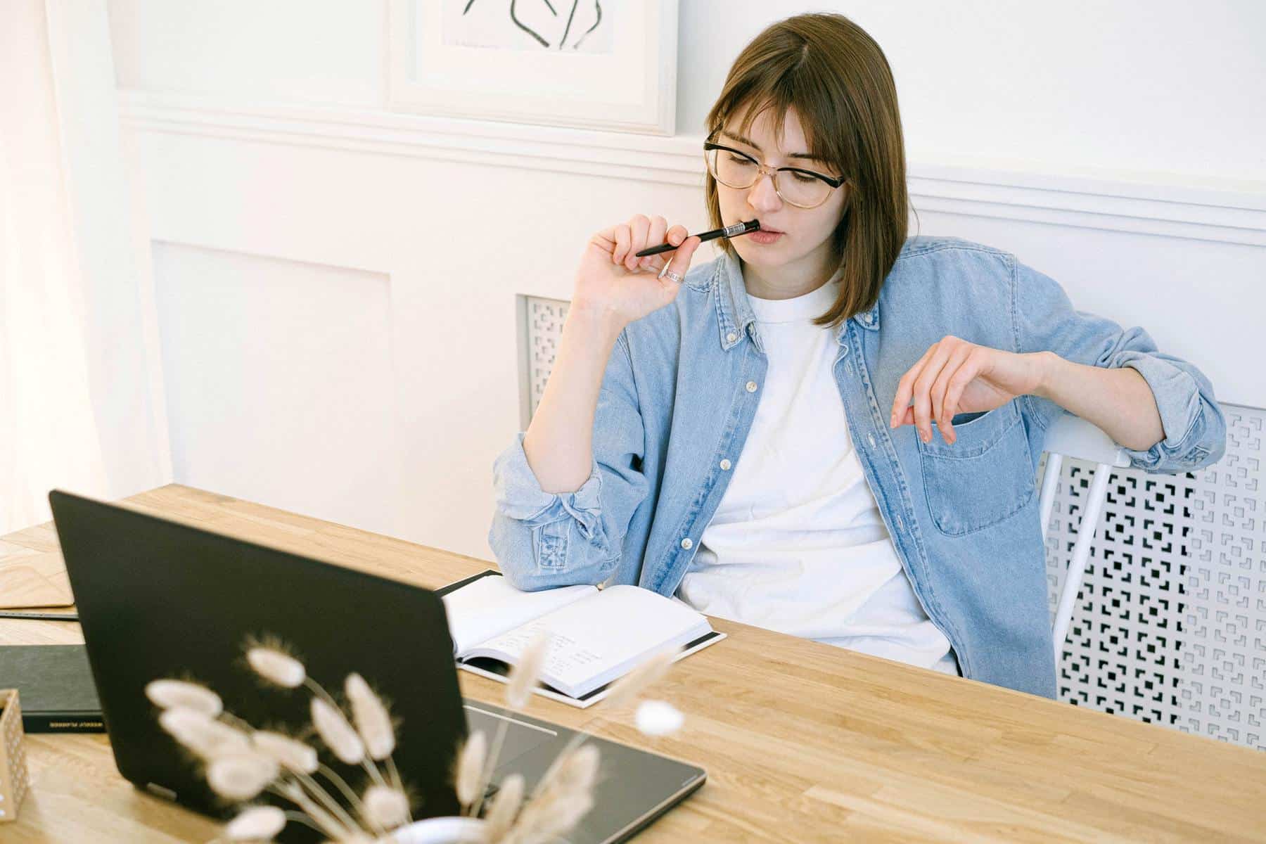 Girl thinking in front laptop