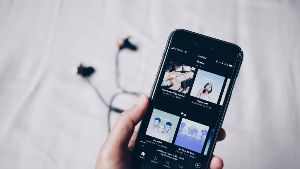 Hand holding phone showing music 