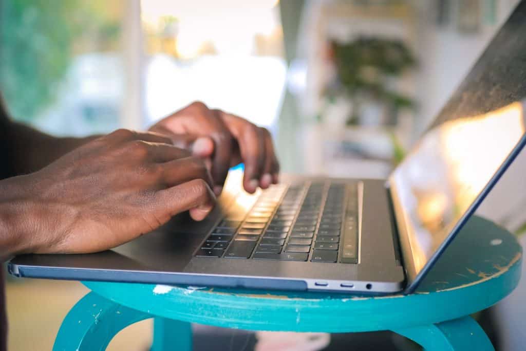 person using silver laptop