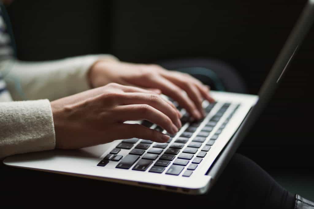 person in white shirt using laptop