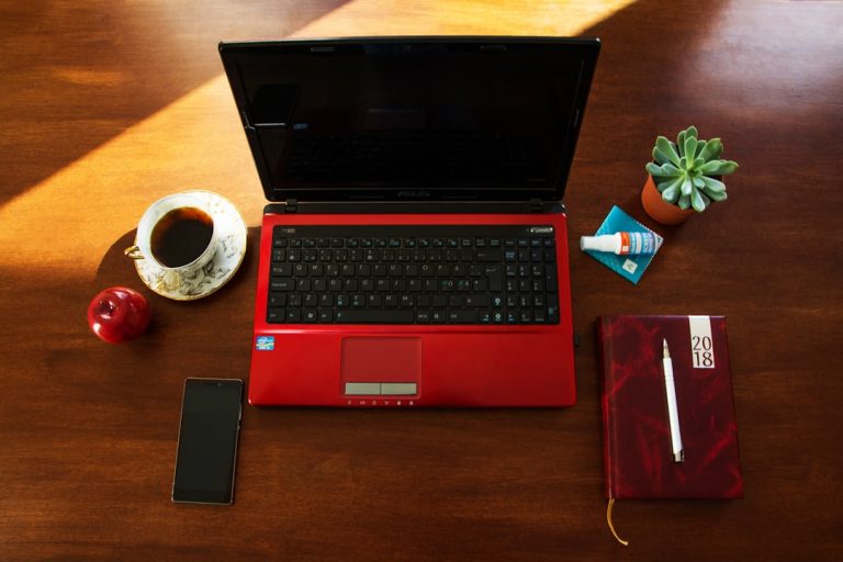 Laptop and accessories on a wooden table. linkedin on phone laptop desktop, business networking