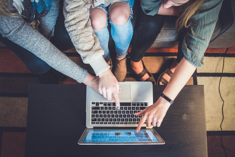 three person pointing the silver laptop computer marketing dashboard telegram channel growth