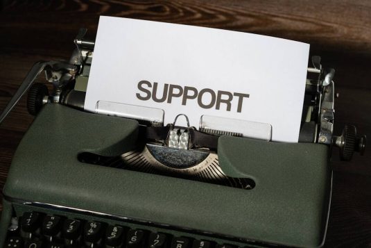 a close up of a typewriter with a paper on it support request email snapchat help