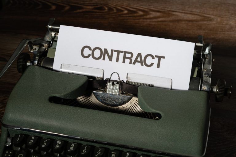 a close up of a typewriter with a sign that reads contact contract approval, legal technology, corporate documents