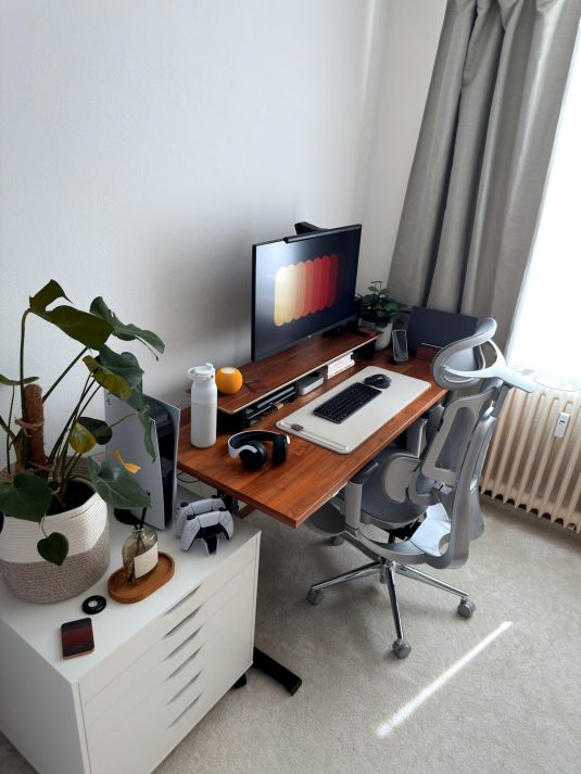 A modern home office desk setup with a computer and chair. freelance developer, minimalist coding interface, zen workspace