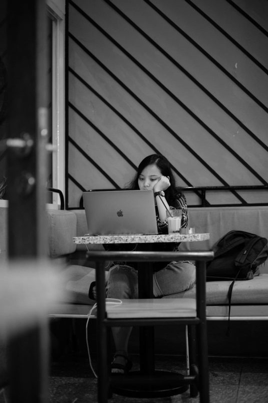 a person sitting at a table with a laptop vpn devices, people troubleshooting, happy user
