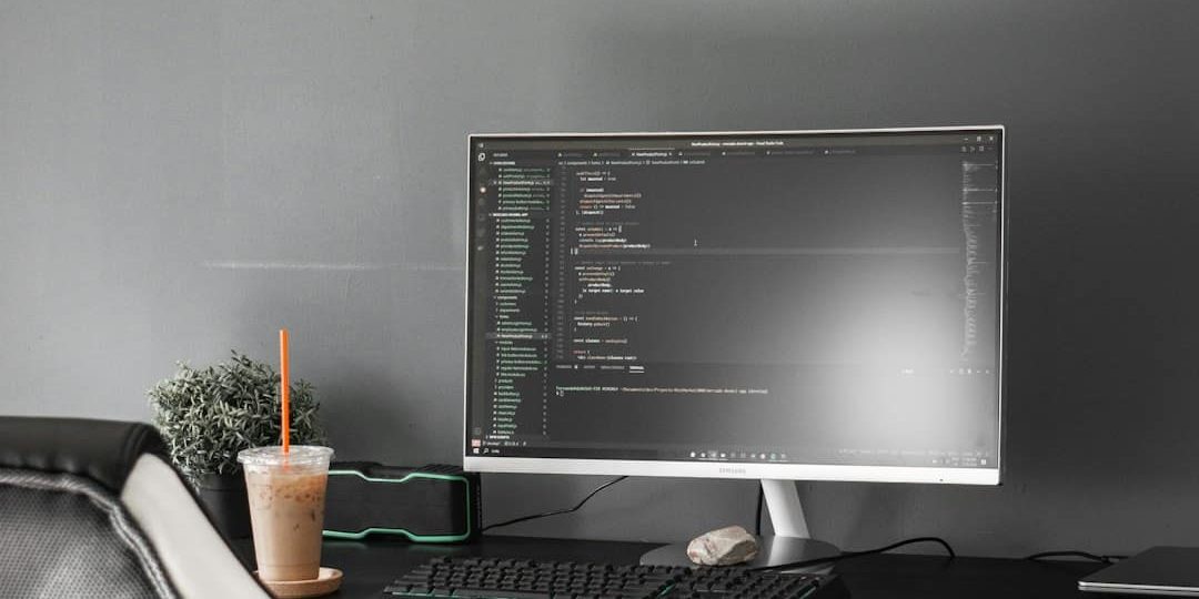 black flat screen computer monitor on black wooden desk AI coding assistant, code generation, developer with laptop