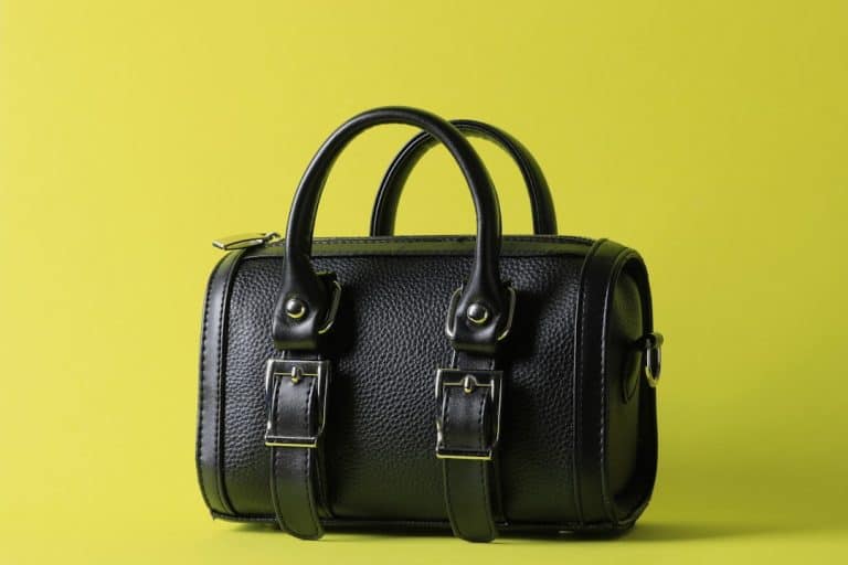 a black leather bag on a yellow background luxury handbag, 3d design, realistic texture