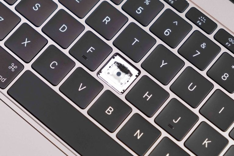 a close up of a laptop keyboard with a chip mac secure erase, data protection, hard drive wiping