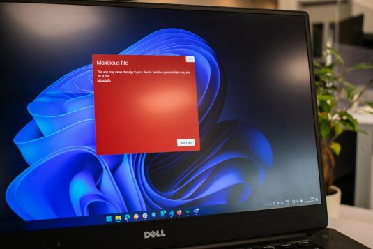 a dell laptop computer with a red screen Windows update error screen, laptop issue, system update failure