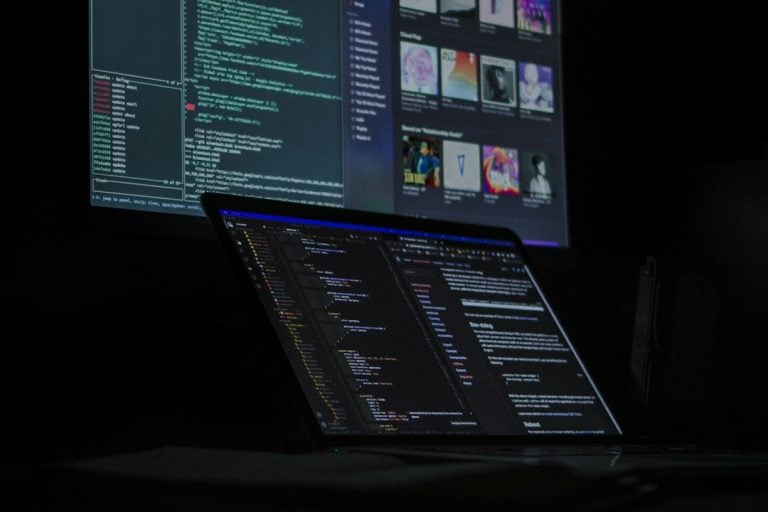 a laptop computer sitting on top of a desk windows task manager, process list, unsecapp exe