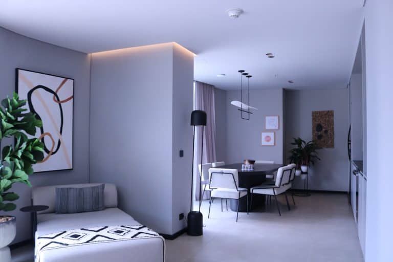 a living room filled with furniture and a painting on the wall ai interior design, room transformation, digital makeover