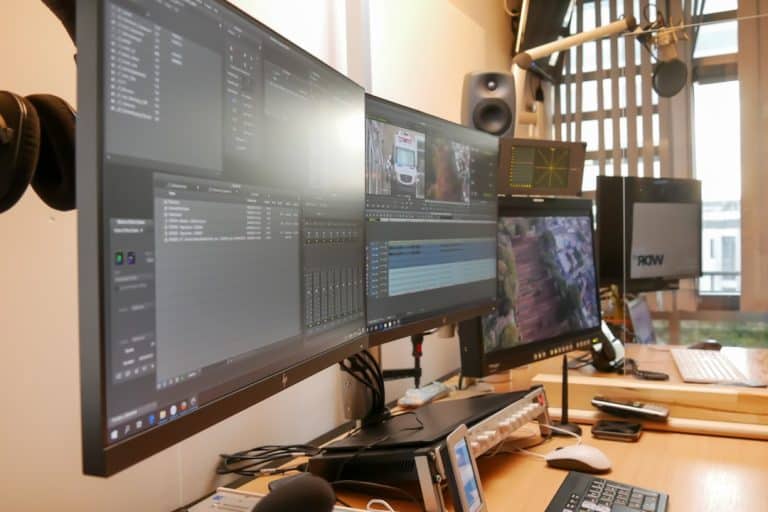 black flat screen computer monitor on brown wooden desk video editing software timeline proxy editing