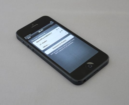 black iPhone 5 settings screen, photos default app, file types