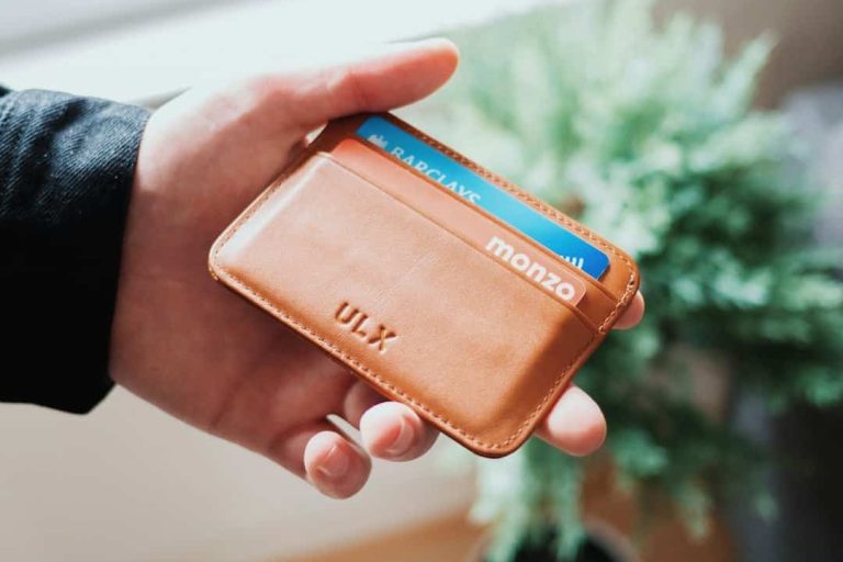 person holding brown ULX leather wallet happy customer, secure crypto wallet, digital payments