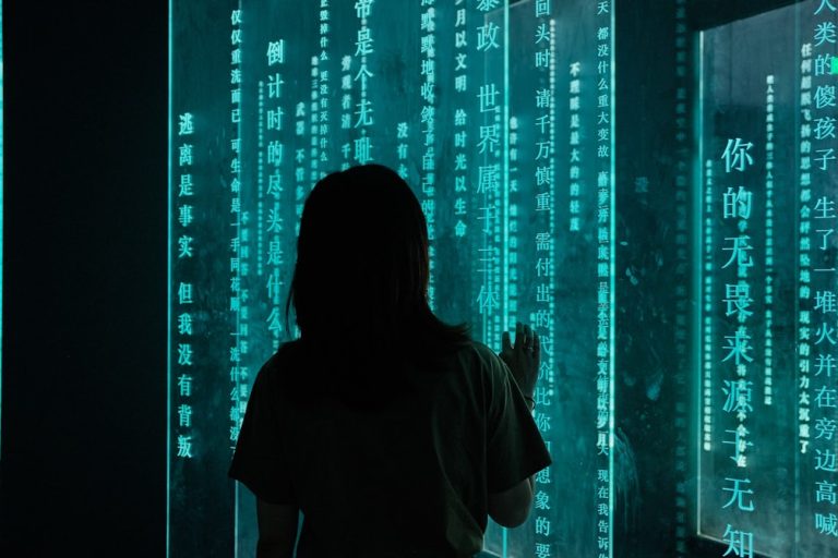 silhouette of woman standing in front of blue light system integration, cyber infrastructure, data flow
