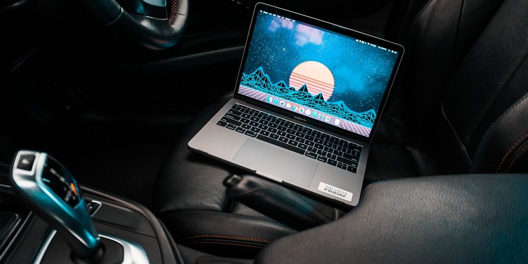turned-on gray laptop computer placed on car bucket seat future tech, car interior, laptop mount, smart car