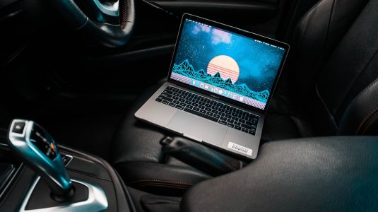 turned-on gray laptop computer placed on car bucket seat future tech, car interior, laptop mount, smart car