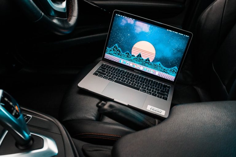 turned-on gray laptop computer placed on car bucket seat future tech, car interior, laptop mount, smart car