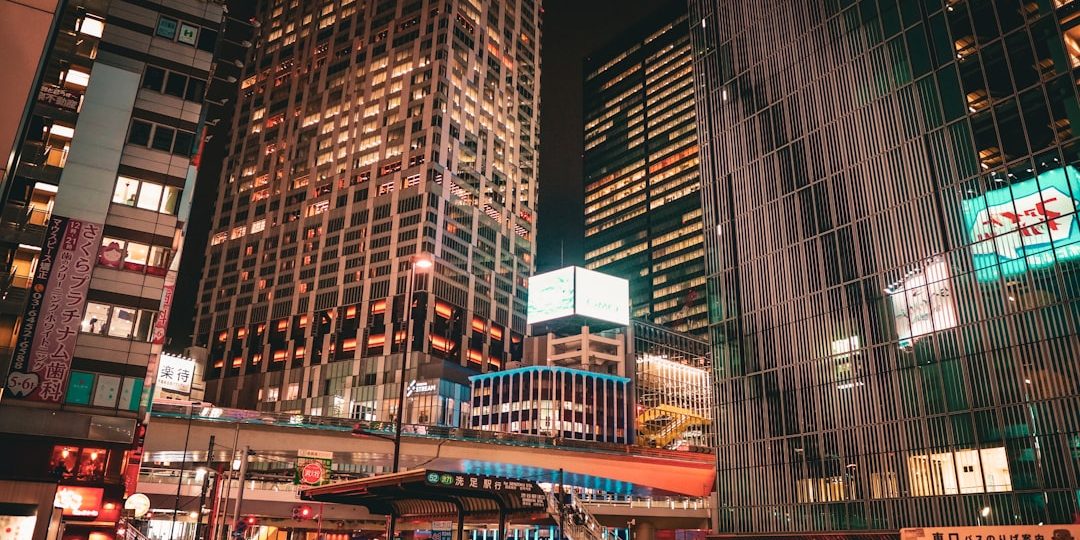 City skyscrapers glow at night. futuristic city, neon lights, night scene
