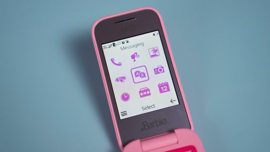 A pink cell phone sitting on top of a table pinterest app screenshot, download image, mobile phone interface