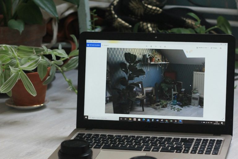 macbook air on white table multiple video apps open screen task manager webcam