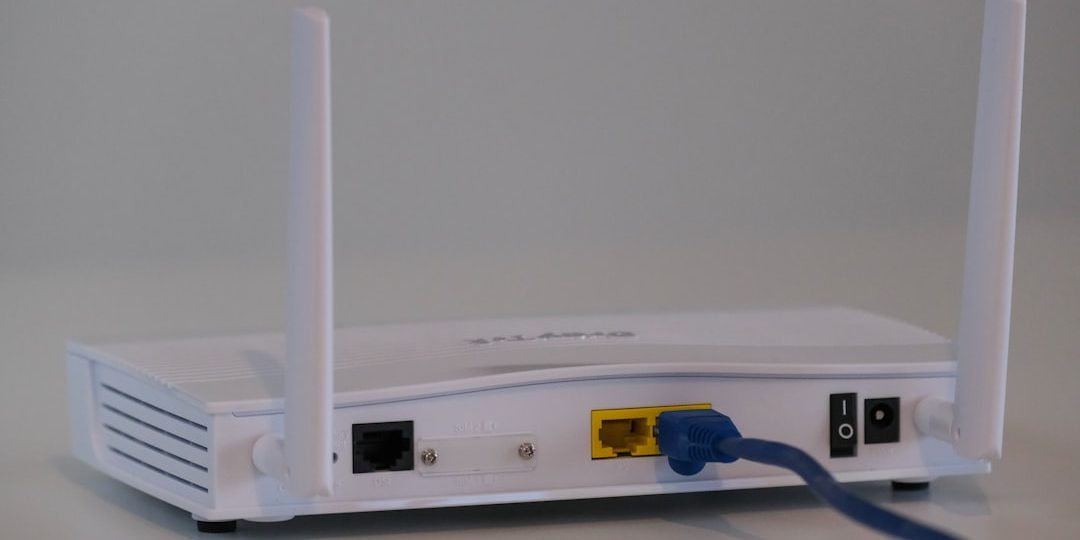white router on white table powerline, ethernet adapter, wall outlet, home network