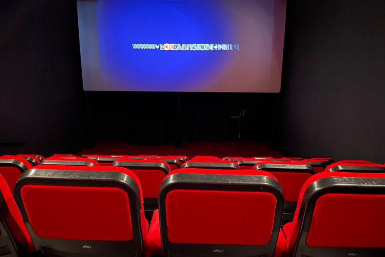 a theater with red seats and a projector screen movie platform, streaming site, watching movies