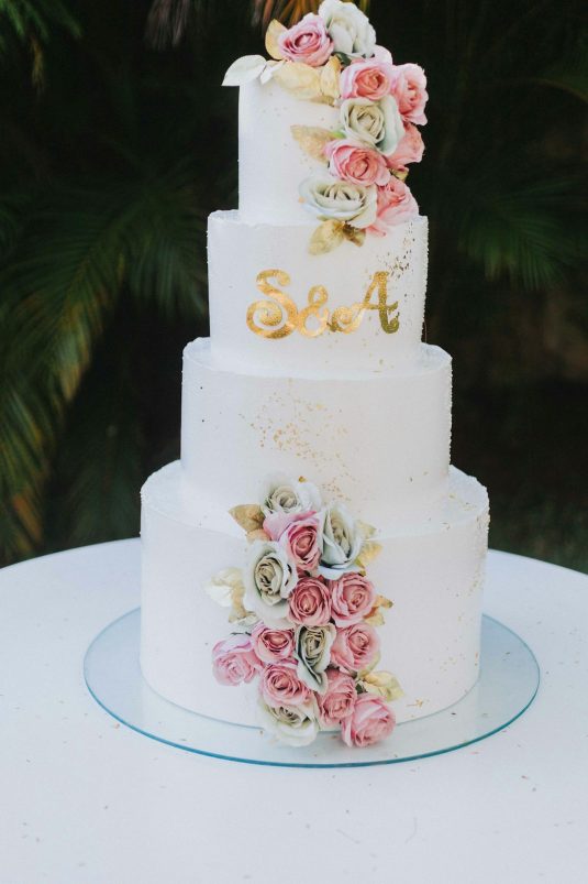 a wedding cake with flowers on top of it floral logo, script font, wedding planner, romantic design