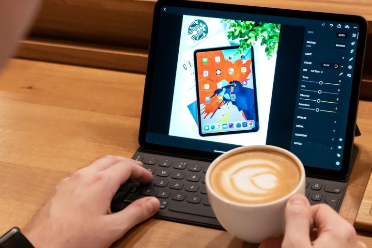 person using laptop ipad writing keyboard cafe coffee