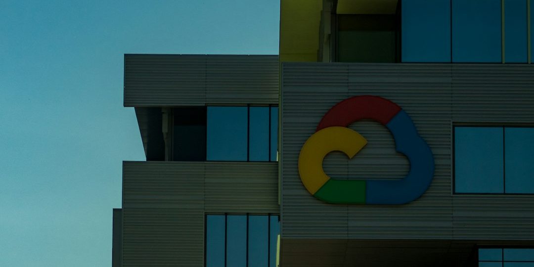 blue and brown concrete building under blue sky during daytime google office, empty desks, tech layoff