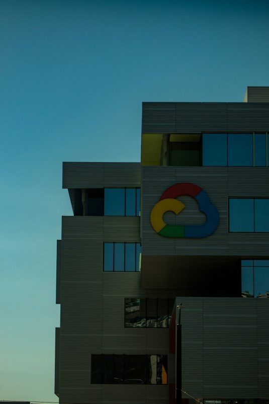 blue and brown concrete building under blue sky during daytime google office, empty desks, tech layoff