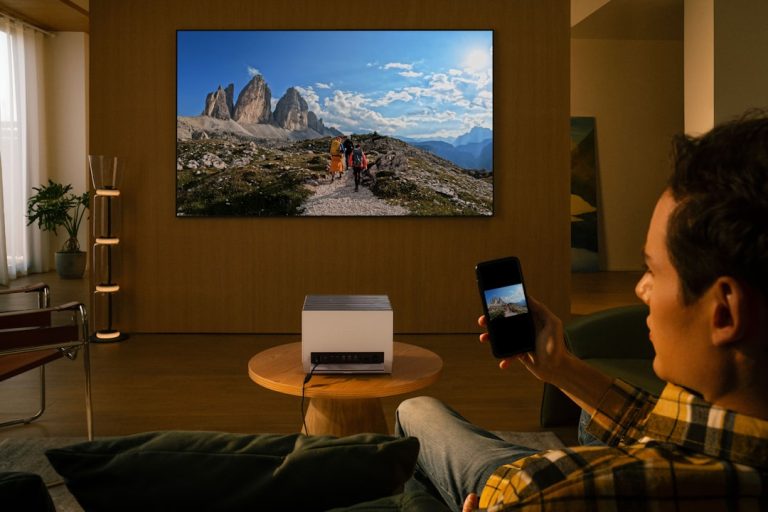 Man uses projector to display mountain landscape on wall. smart tv, video streaming device, lag, frame drops
