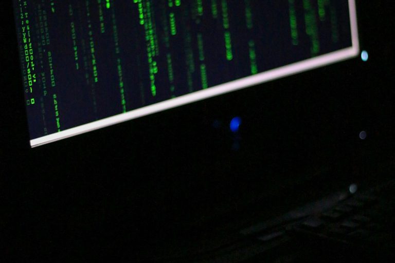 A computer monitor sitting on top of a desk mystery code computer dark web