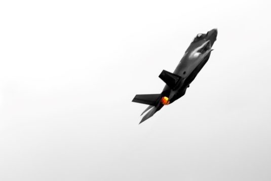 A stealth fighter jet soars through the air. war thunder launcher, war thunder install, game download progress