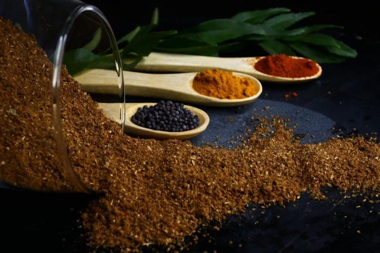 various spices and spoons on a table fresh ingredients, zaatar, bok choy, grains, spices